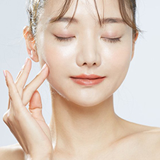 A photo of a woman in pain holding her jaw. Lumier Medical provides Masseter Botox treatments